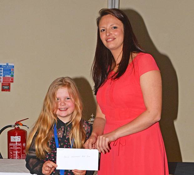 Anna Mortimer receiving her prize for the novice handler section from Jessica Miller